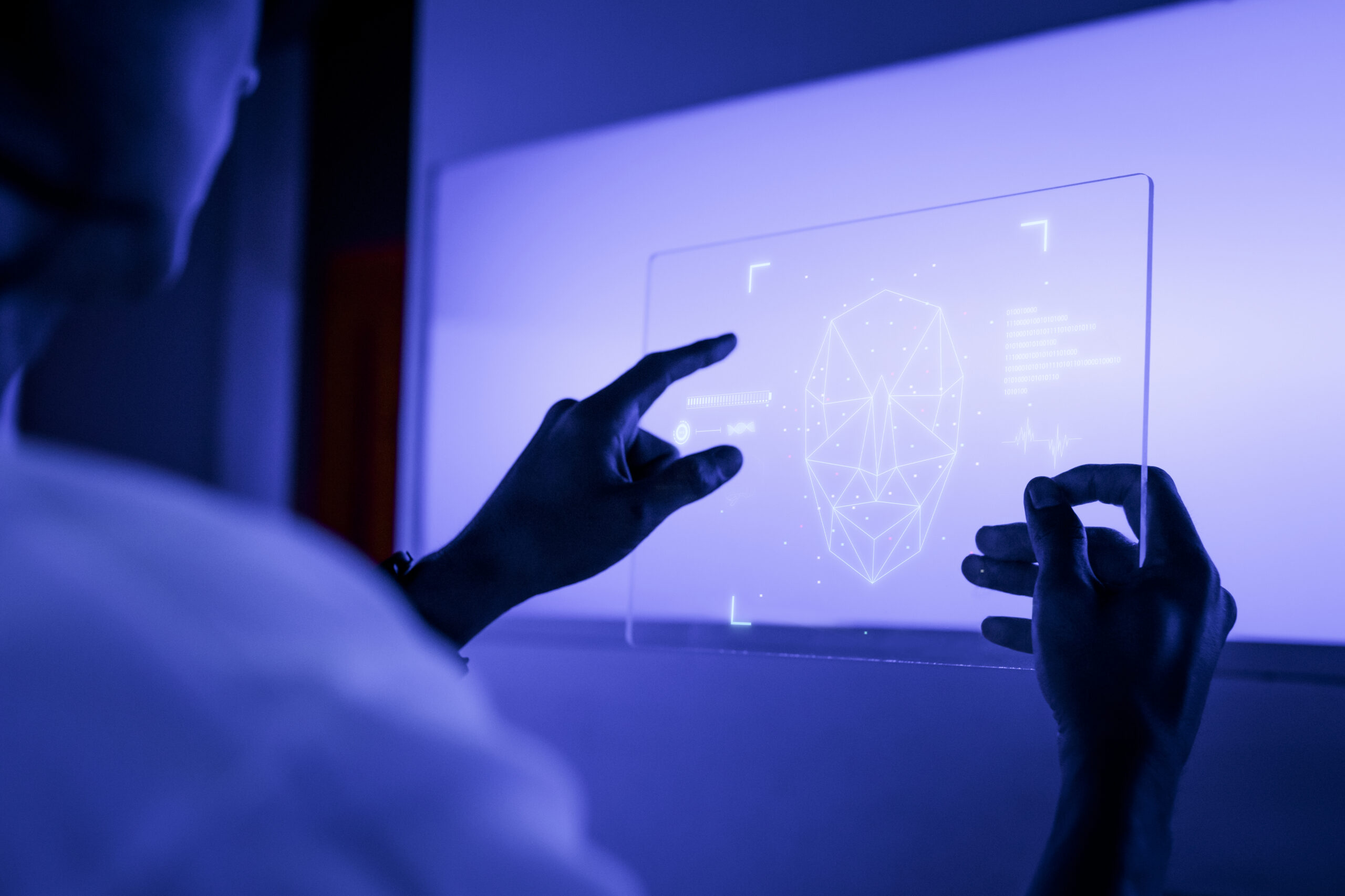 designer using a transparent digital tablet screen futuristic te