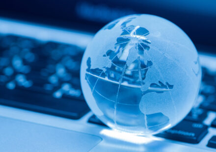 the business concept of the glass world on a laptop